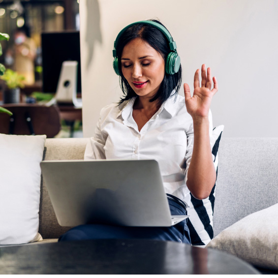 woman raising her hand and on a laptop